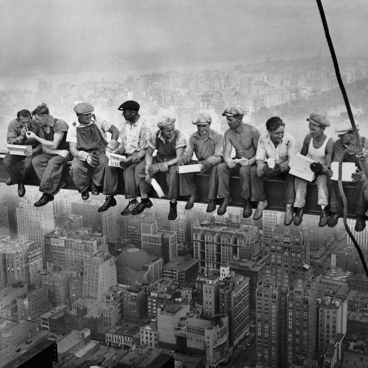 Restored lunch atop a skyscraper, showcasing the transformation from a faded, damaged image to a vibrant, clear restoration. The restored image features a bright blue sky, sharp details of the skyscraper, and vivid colors in the lunch items. before enhancement and upscaling