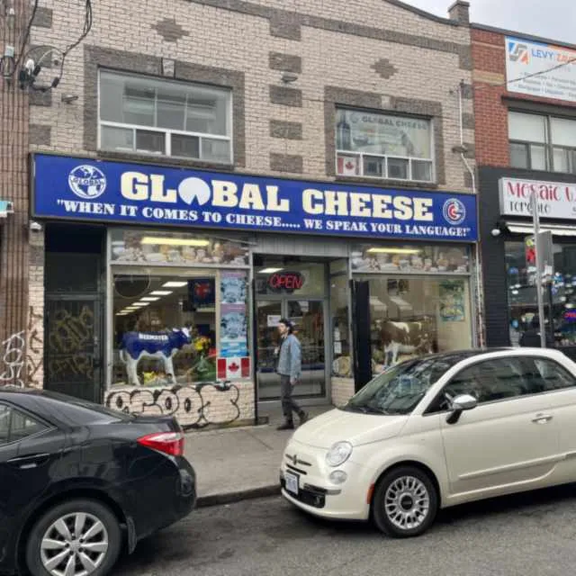 Storefront photo upscaled with the shop signage, lettering, and brand colors kept exactly consistent before enhancement and upscaling