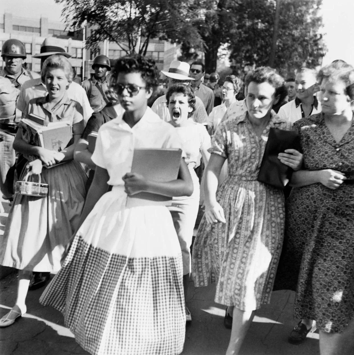Elizabeth Eckford walking with dignity as she attempts to enter Little Rock Central High School, surrounded by a hostile crowd. before enhancement and upscaling
