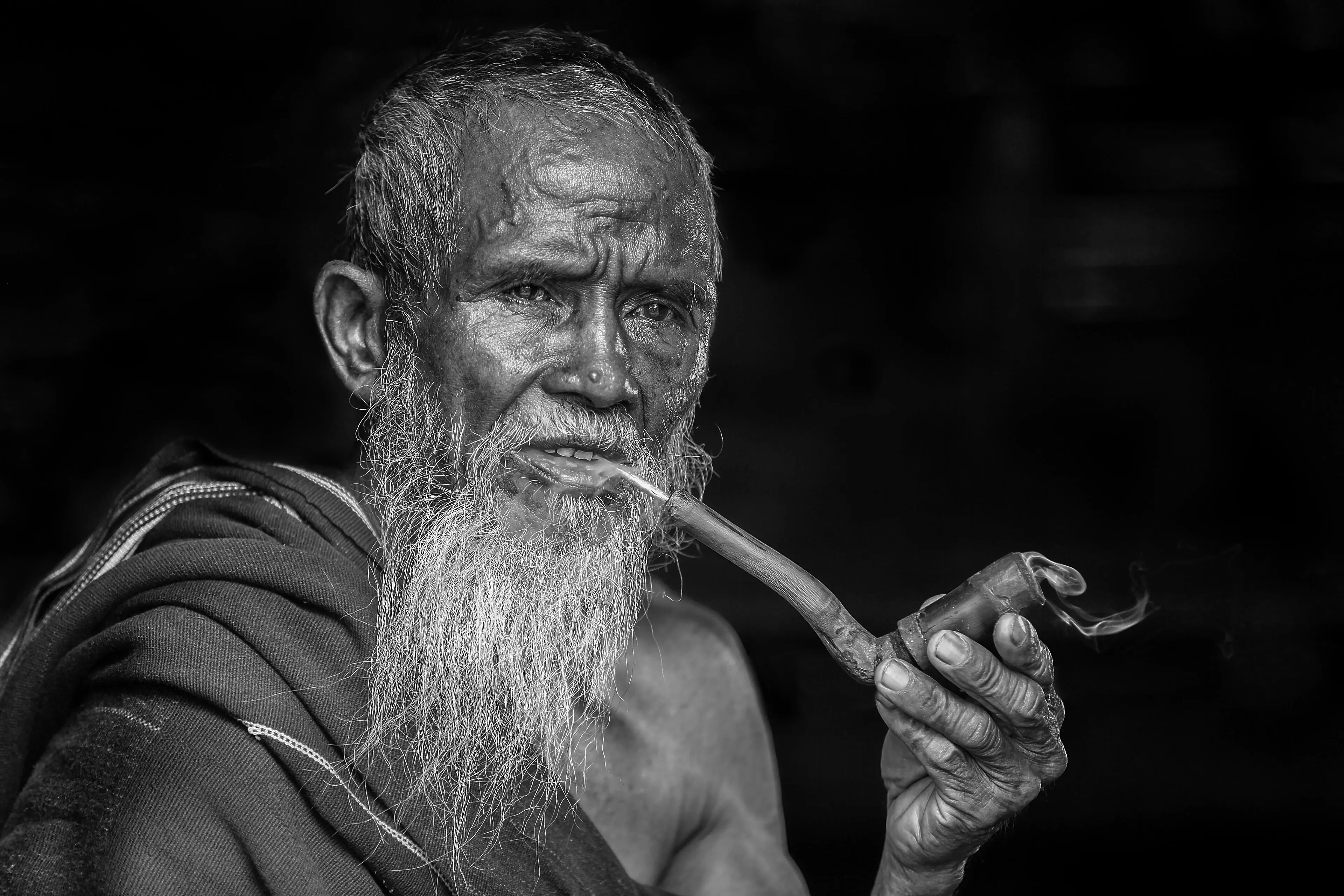 Bearded man smoking a pipe, a real photo enlarged faithfully with skin and hair texture sharpened and nothing invented after enhancement and upscaling