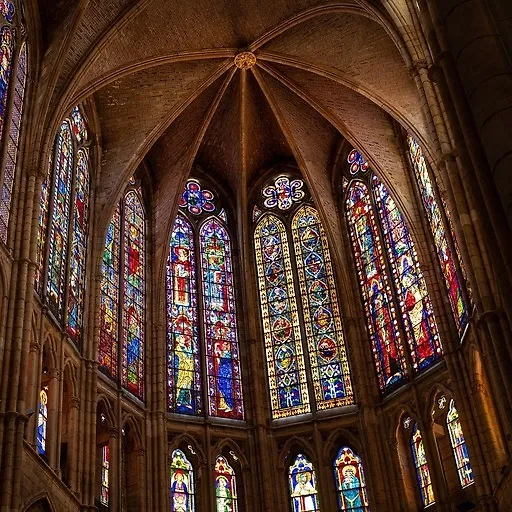 Majestic Gothic cathedral interior with towering stained-glass windows casting colorful light onto the stone walls before enhancement and upscaling