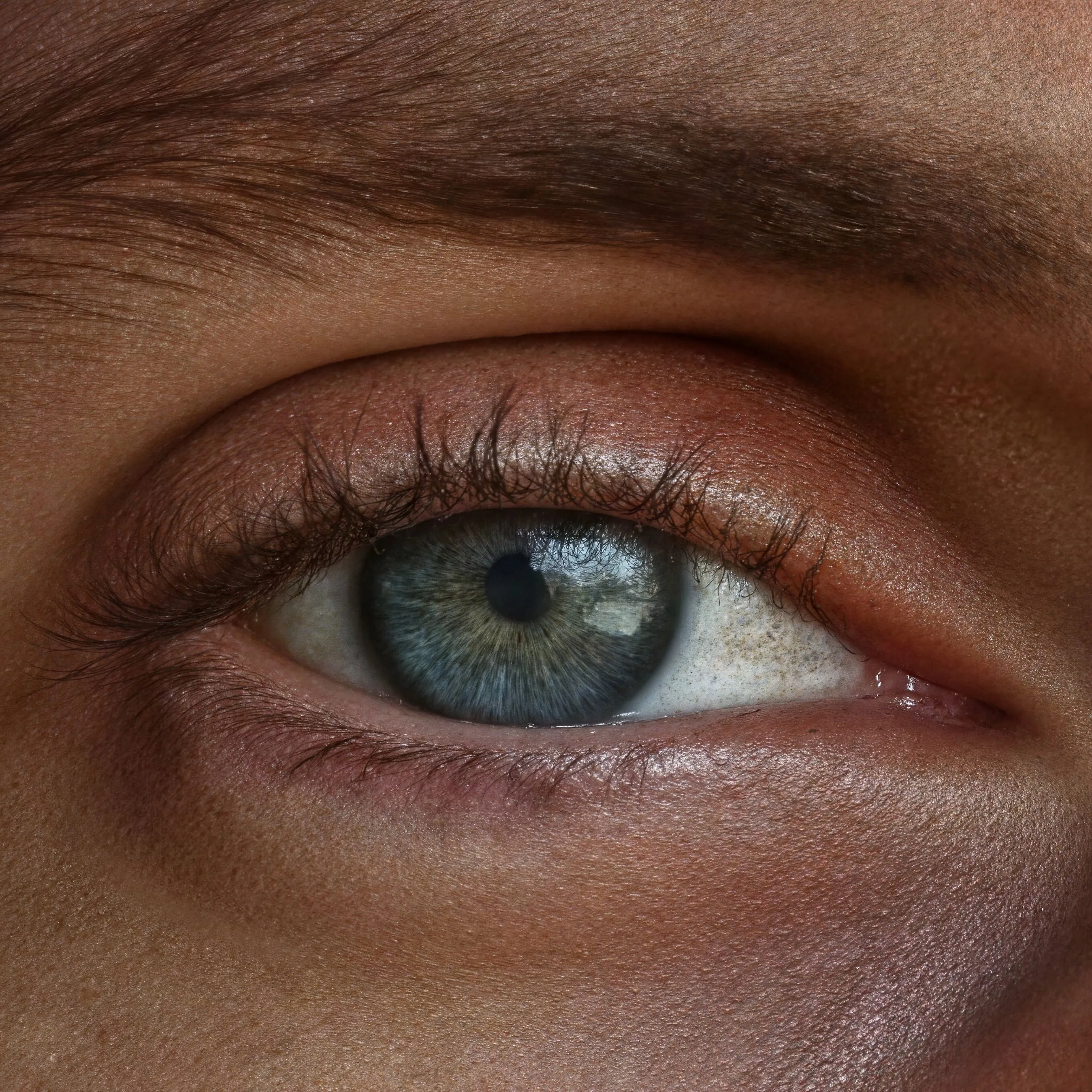 Extreme close-up of a blue-green human eye with intricate iris details, long eyelashes, and natural skin texture after enhancement and upscaling