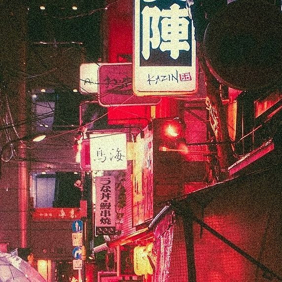 A narrow urban alley filled with bright, neon-lit signs in a Japanese cityscape at night. The scene is vibrant, dominated by red, pink, and orange hues, giving it a warm, slightly surreal atmosphere before enhancement and upscaling